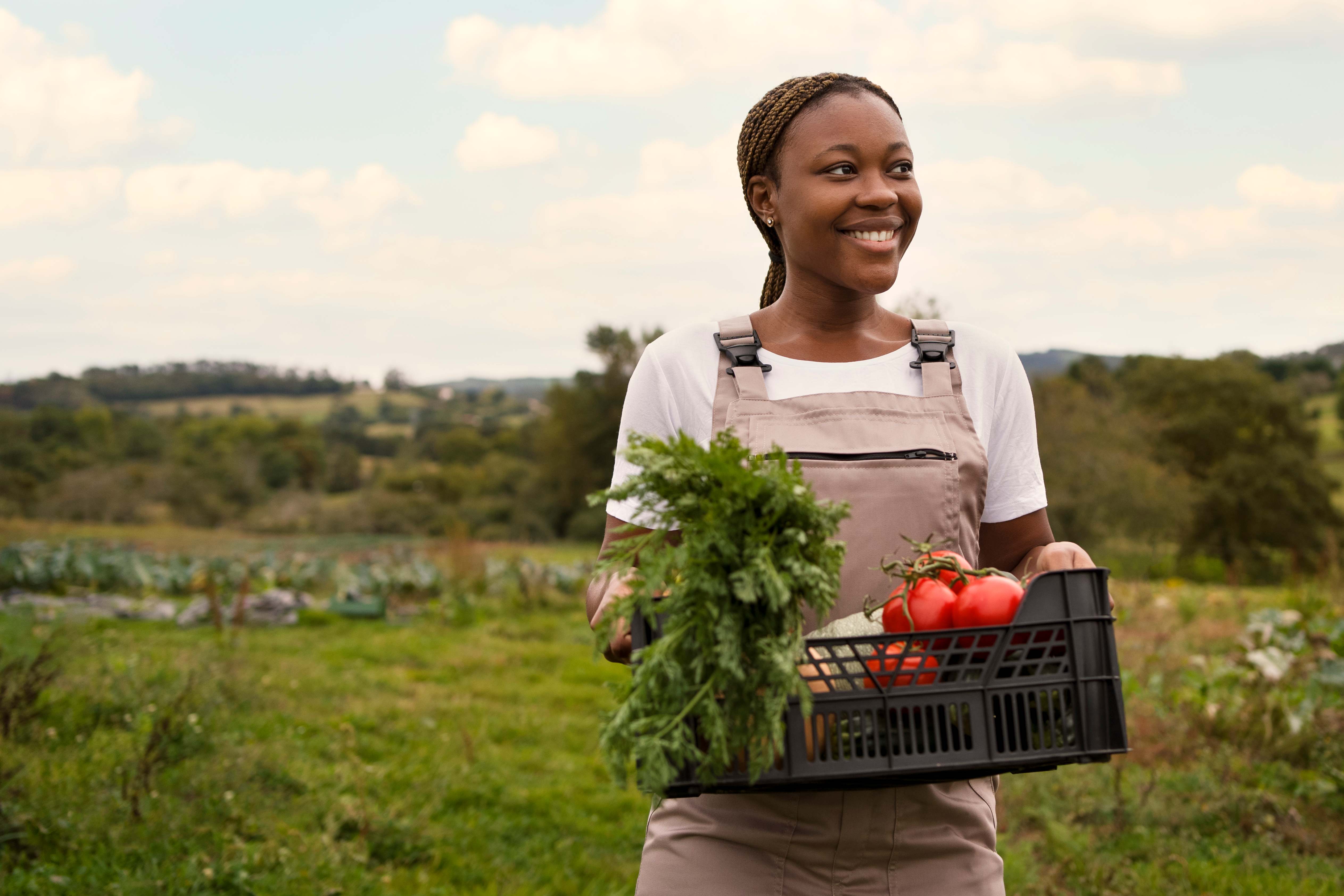 Smiling African woman farmer with fresh harvest
